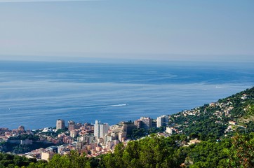 Fototapeta na wymiar aerial view of Montecarlo, France, with its modern skyscrapers from the heights behind the city