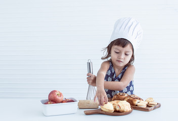 A little girl is making bakery