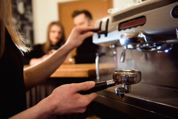 Female starting her day on a new job as a barista. Working in a cafe.