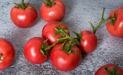 Fresh tomatoes in a plate on a dark background. Harvesting tomatoes. Top view