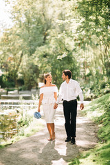 Beautiful Bride And Groom Walking Holding Hands In Park