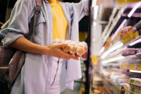 Young Woman Buying Groceries In Supermarket