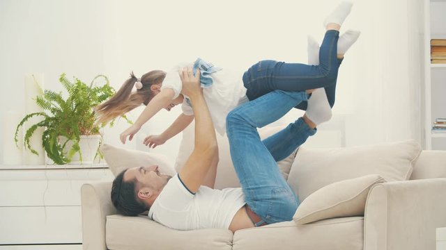 Daddy Trying To Entertain Somehow His Daughter In 4k Slowmotion Video.