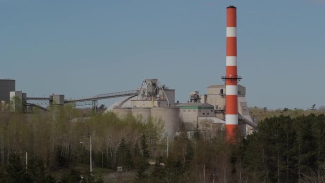 Industrial cement plant buildings and smoke stack   