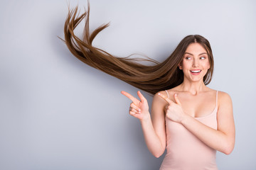 Close-up portrait of her she nice attractive lovely pretty cute cheerful brown-haired girl wind blowing hair showing new novelty solution isolated on light gray pastel color background
