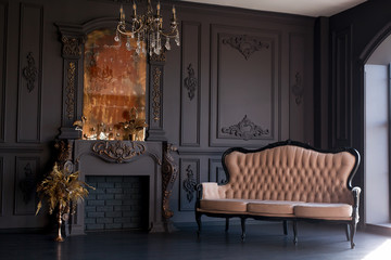 Obraz premium Black room interior with a vintage sofa, chandelier, mirror and fireplace