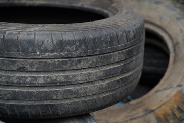 Fototapeta premium Old used tires in the garage 