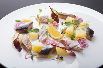 Salted herring fillet slices served with onion