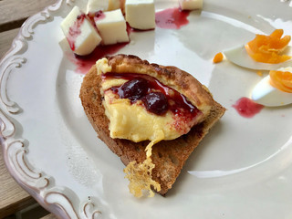Dutch Baby German Pancake Slice with Cherry Jam / Marmalade served in Plate for Breakfast.