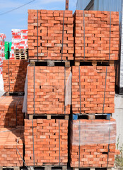Bricks on pallets. Storage of bricks at construction site.
