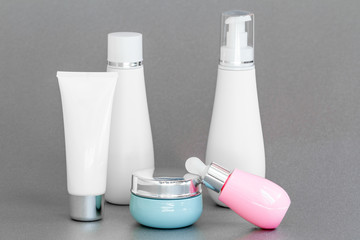 blank bottle packaging with natural cosmetic cream, serum, skincare, lotion, tonic. bio organic product on gray background. spa concept. Cosmetic design template. Plastic bottle label design