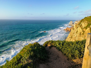 Cabo da Roca or Cape Roca is a cape which forms the westernmost point of the Sintra Mountain Range, of mainland Portugal, of continental Europe, and of the Eurasian land mass
Cabo da Roca, the western