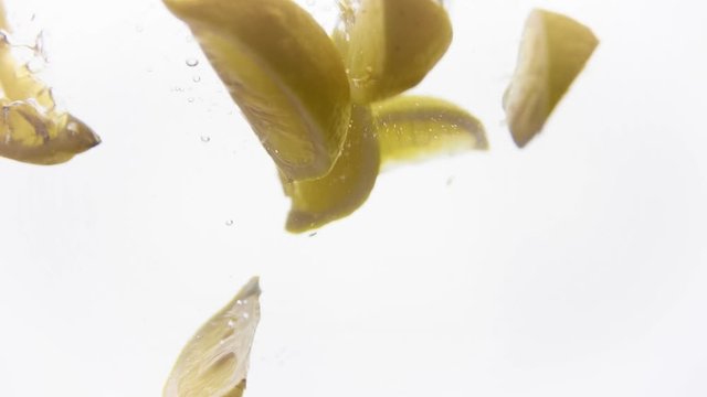 Bright parts of lemon under water. Tasty and healthy food