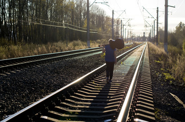 a blonde teenage boy with a guitar on a railway, spring, adolescence and romance, first love,...