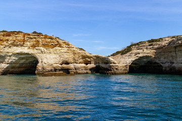 Caves and arches in the rock formations along the coastline, Algarve, Portugal.