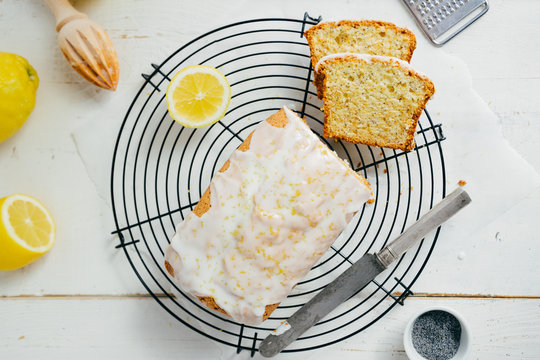 Glazed lemon pound cake loaf with poppy seed on cooling rack