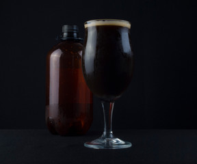 This bowl is made of crystal. The beer is a Dry Stout with grape must Tannat, Cabernet Franc, and Petit Verdot. Photo produced in low light, black background, lower exposure.