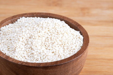 White sesame.White sesame seed on wooden bowl for healthy eating. White Sesame seed in bowl.