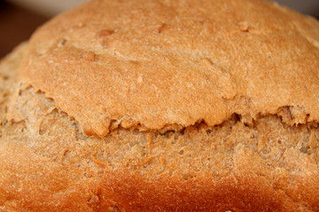 beautiful freshly baked loaf of homemade bread with a golden brown crust close-up, the concept of home-made cuisine, organic food, healthy eating