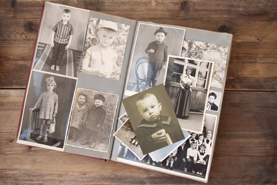 old retro album with vintage monochrome photographs in sepia color, the concept of genealogy, the memory of ancestors, family ties, childhood memories