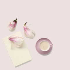 beautiful tender still life, card on a beige background, magnolia buds, a cup of cappuccino, concept of a floral spring background