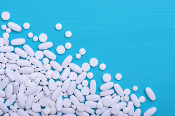 Heap of pills on blue