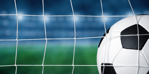 Soccer ball in goal on stadium