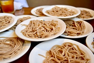 Many small plate of soba in Japanese restaurant.