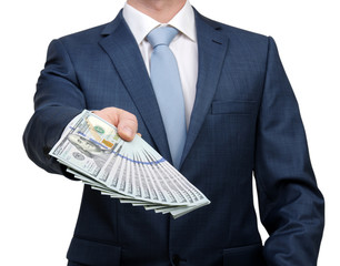 Businessman holding money cash in hands of passing them to the client.