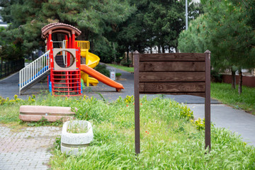 Big blank wooden billboard on green backround