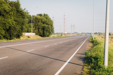 Fototapeta premium Asphalt highway near Dnipro sity in the summer. Road perspective