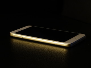 White smartphone isolated on black background