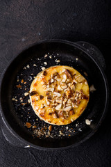 Baked or fried Camembert or brie cheese with nuts  and honey. Gourmet Breakfast.