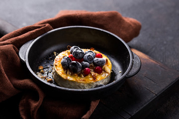 Baked or fried Camembert or brie cheese with berry and honey. Gourmet Breakfast. Selective focus