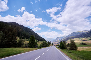 Fototapeta premium Asphalt road in Alps mountains. Road trip concept.