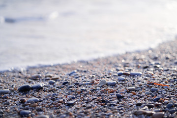 Pebbles on the sea beach. Background and texture. Travel and adventure.