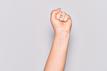 Hand of caucasian young woman doing protest and revolution gesture, fist expressing force and power