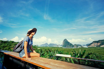 Traveling by Thailand. Young tourist woman enjoying wonderful view of Phang Nga bay with rock islands.