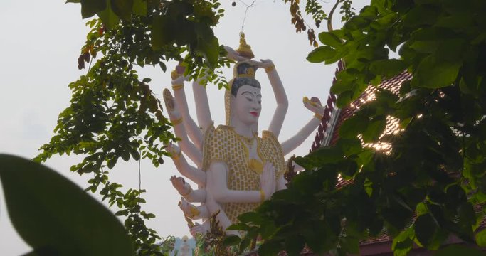 Imposing Hindu Goddess Kali Meditates Peacefuly while Nature Dance Around her in Thailand, Daylight 4K