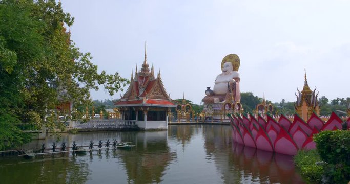 Smiling Big Buddha Stands on a Colorful Temple in Thailand. Daylight, 4K