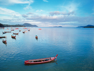 Travel Asia. Beautiful tropical seascape.Traditional thai longtail boats in blue lagoon Rawai beach in Phuket island.