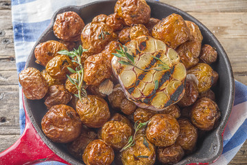 Baked in frying pan whole young potatoes, homemade bbq vegetarian food