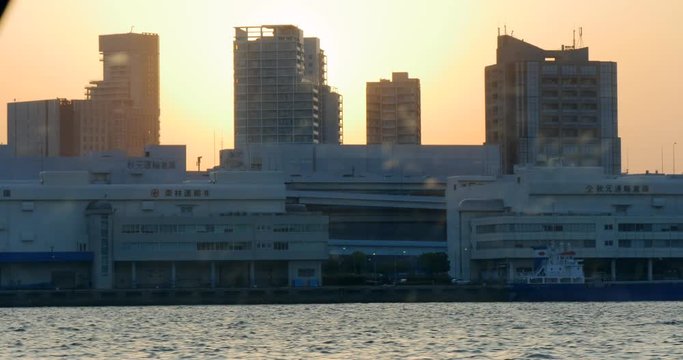 Boat Trip and Tokyo City view Through a Glass. Sunset Light Between Buildings, Japan 4K