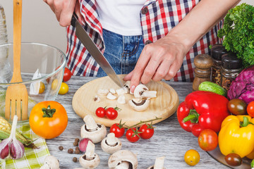 Woman cooks at the kitchen, body part, blurred background