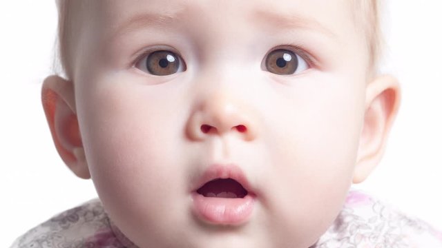 Face transformation of the little girl. Face of the infant baby seven monthes old smoothly transforms into the face of the same baby of one year old