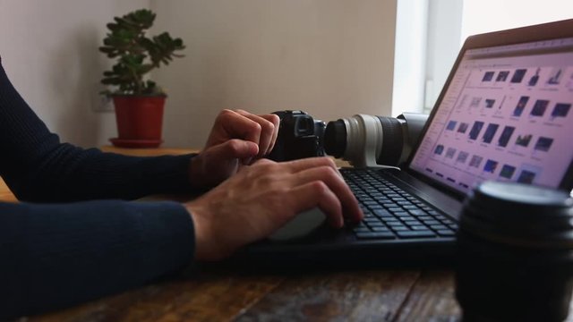 hands of a man who works on a laptop at home