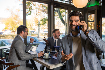 Businessman talking on the phone in the office at meeting