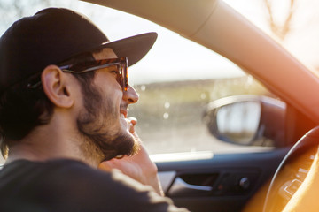 Boy in the car with the phone in his hands