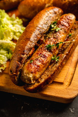 Tasty fresh hot dogs with grilled sausage on the rustic background. Selective focus. Shallow depth of field.