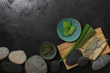 fresh aloe vera blower with spa stones on dark background